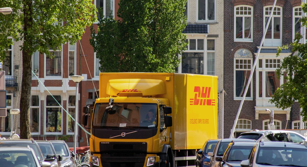Gelber DHL-Lkw in einer europäischen Stadtstraße